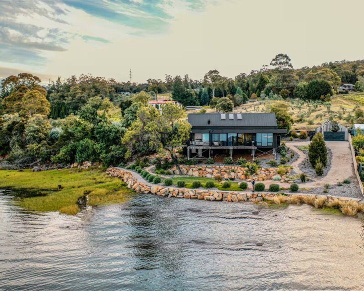 A view of the house by the water at Deviot Boat House best Airbnbs Launceston