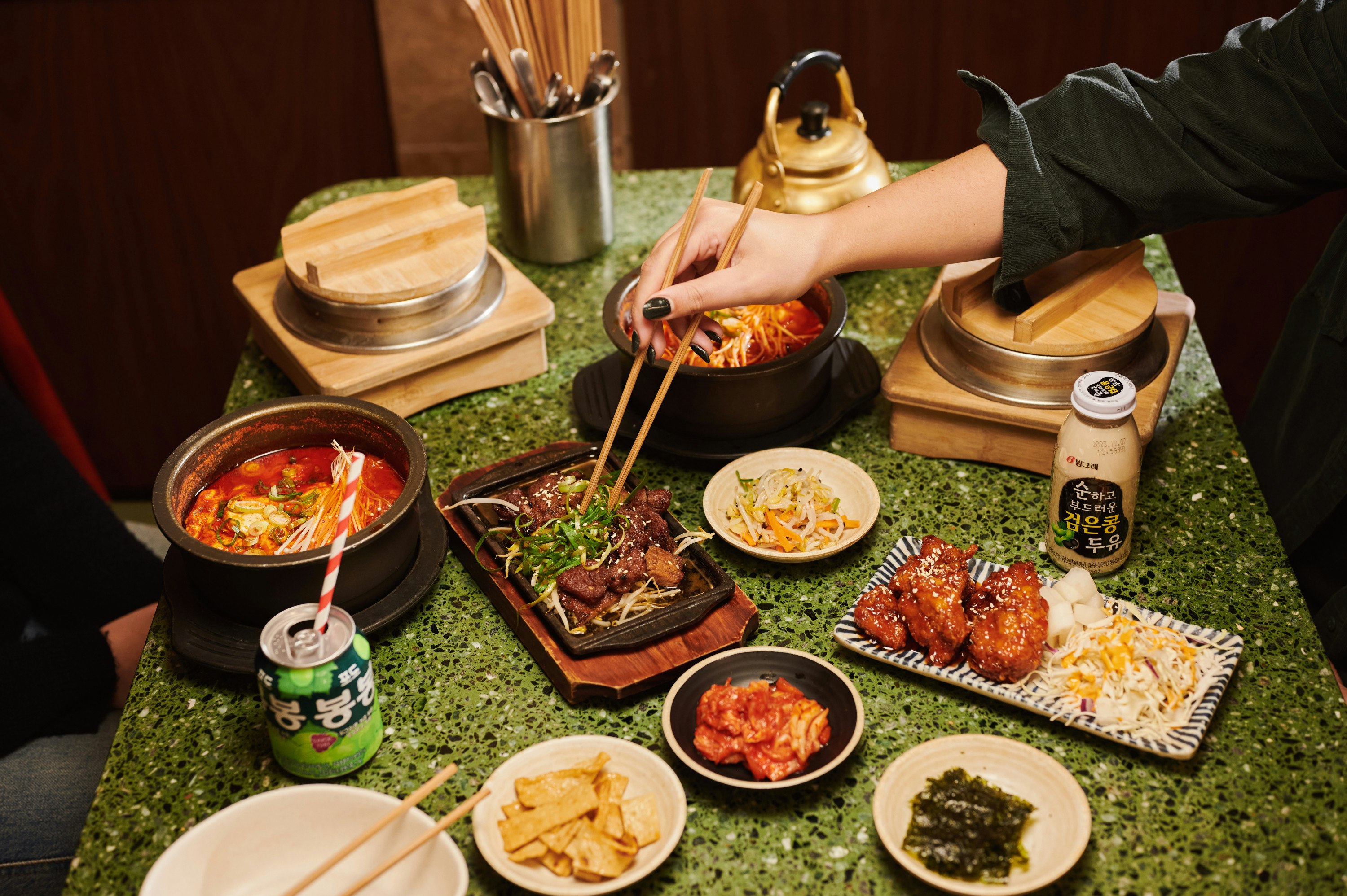 Plate of food with hands using chopsticks