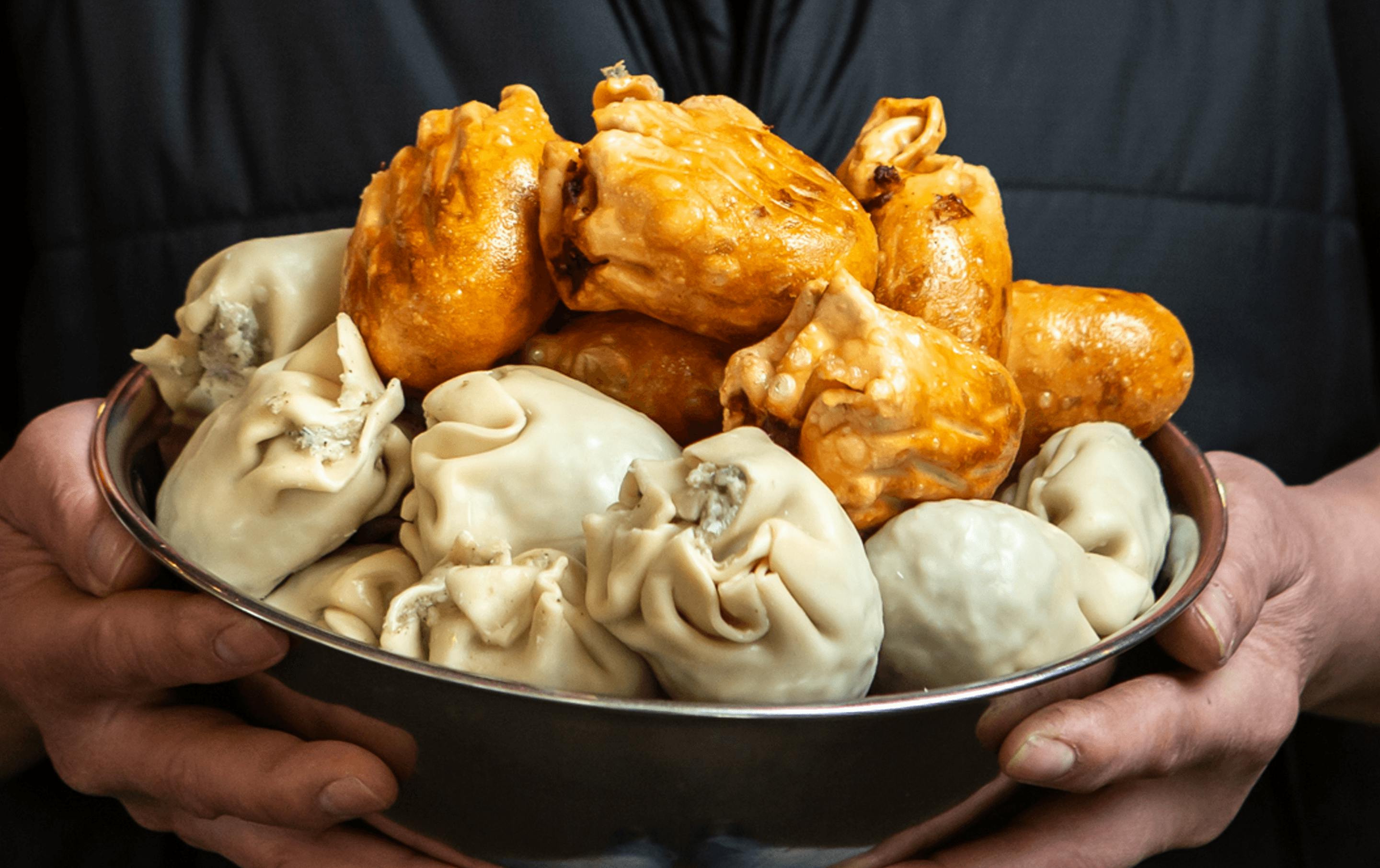 A bowl of fried and uncooked dim sims. 