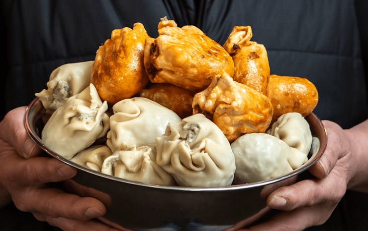 A bowl of fried and uncooked dim sims. 