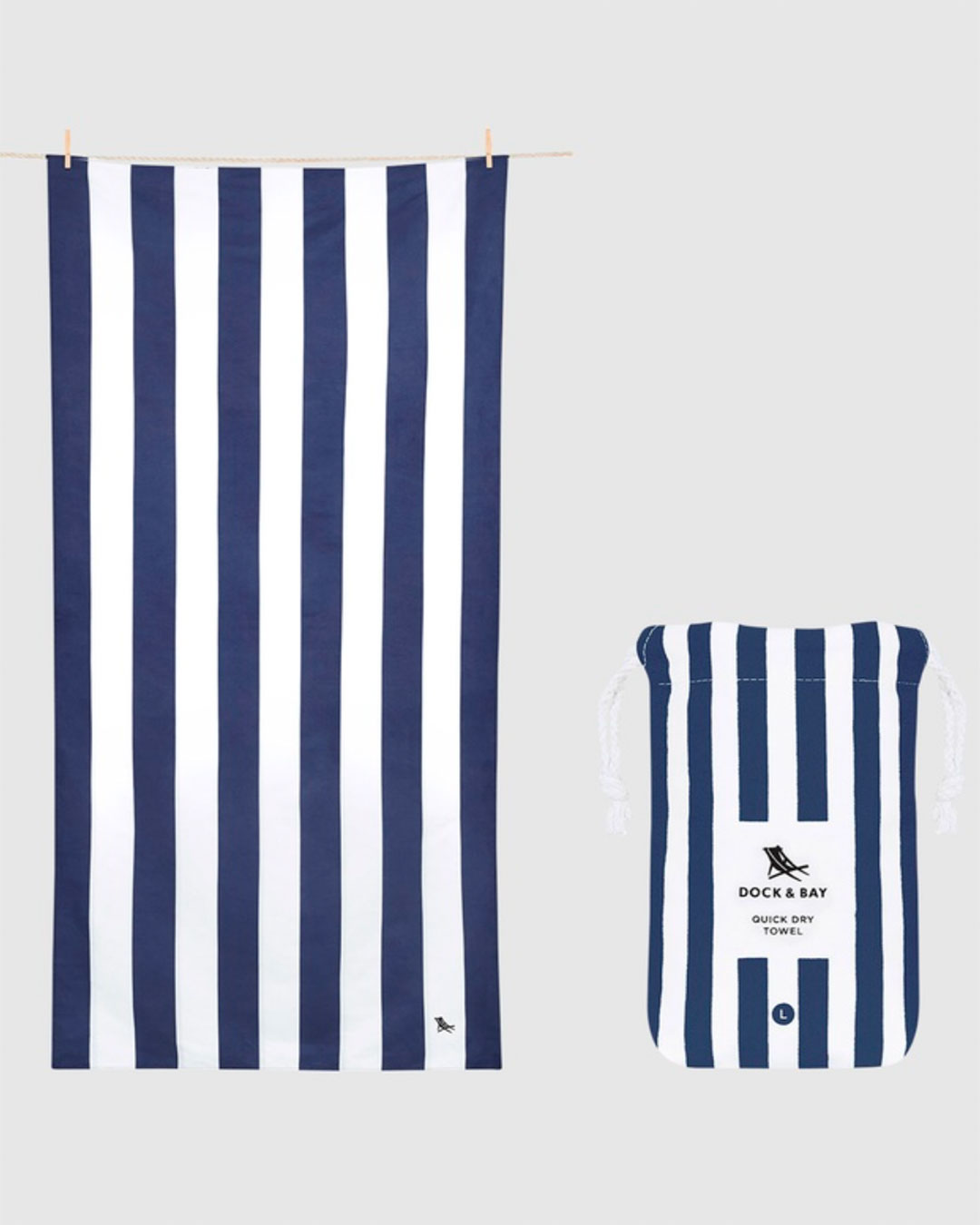 A large dark blue and white striped beach towel with a matching drawstring bag.