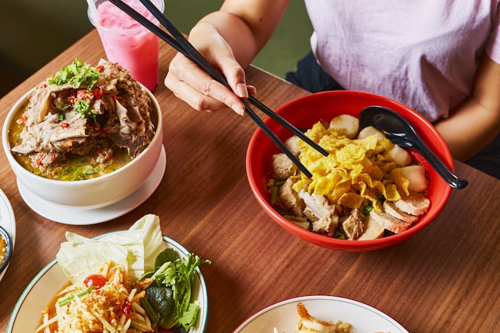Food spread with hand using chopsticks 
