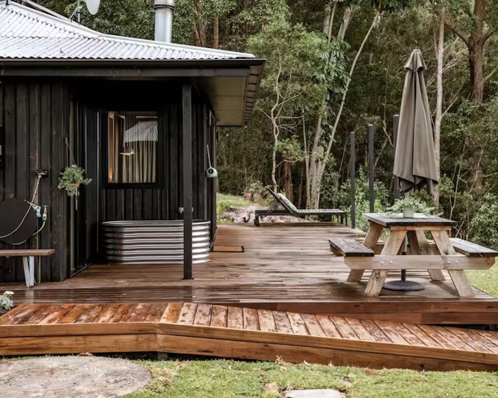 A view of the outdoor bath sitting outside Donnington Ridge Eco Cabin Airbnb one of the best accommodation options near Maleny