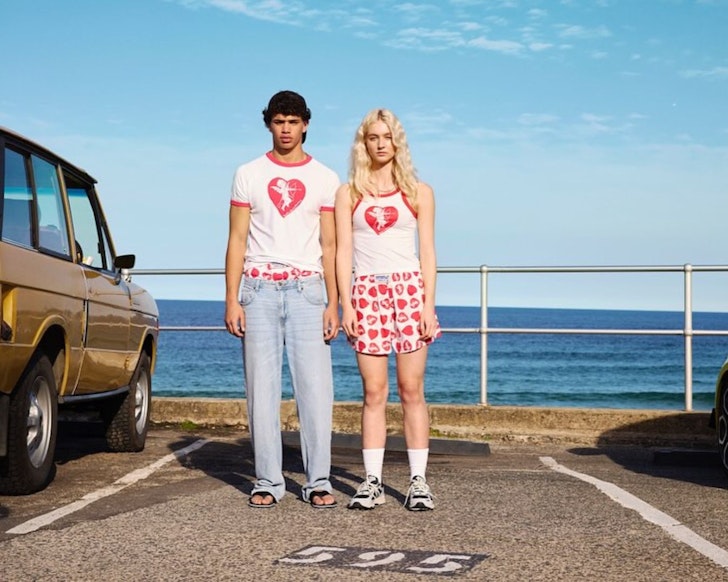 A man and woman stand in a parking space at Bondi wearing Double Rainbouu one of the best Australian fashion labels