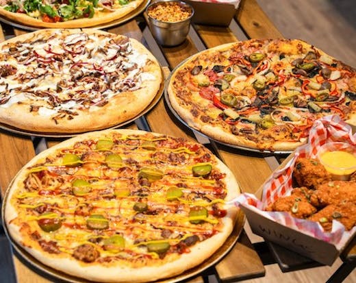 Image of pizzas and wings from Dough Boys