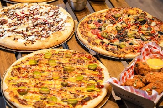 Image of pizzas and wings from Dough Boys