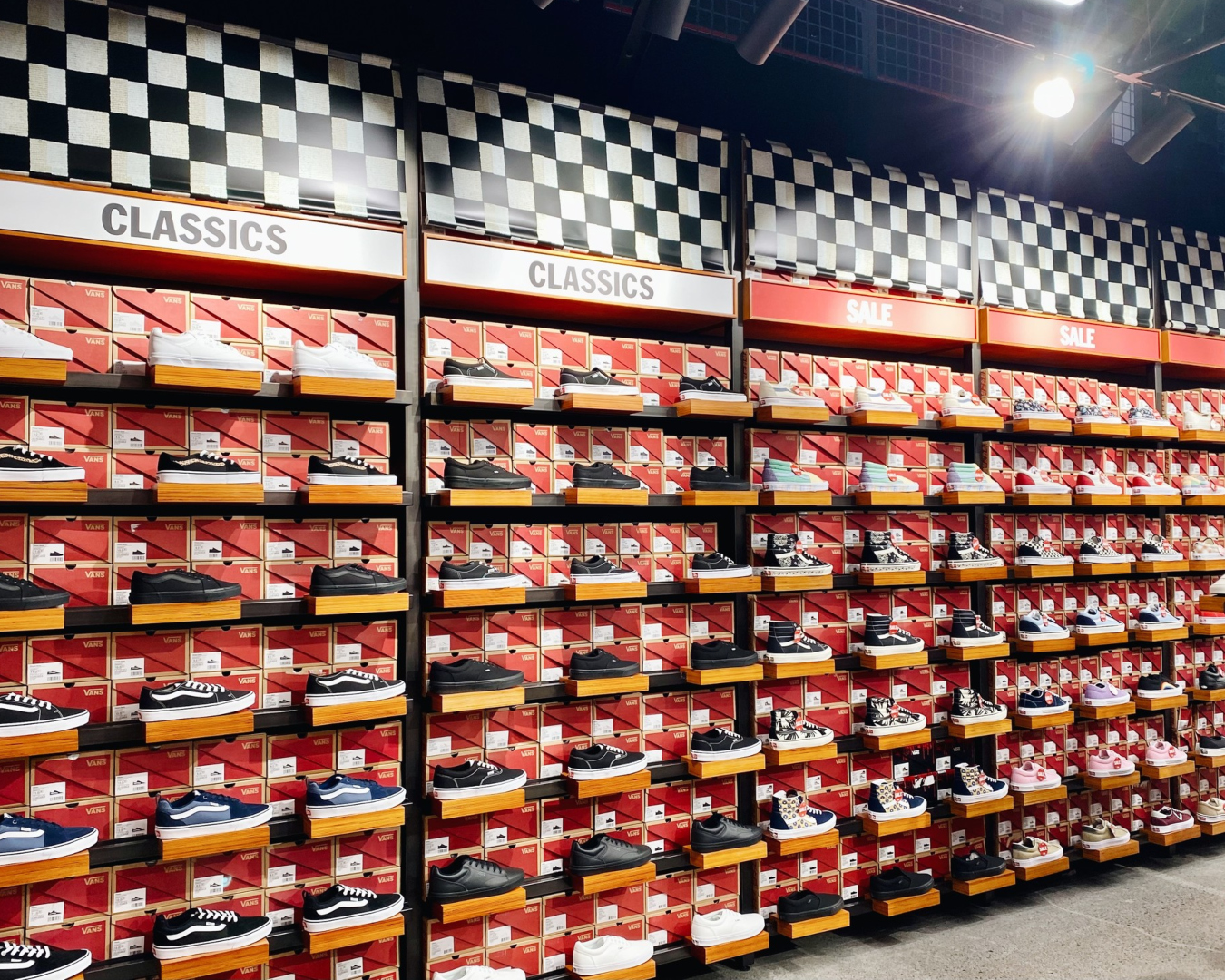 A wall filled from floor to ceiling with Vans skate shoes. 