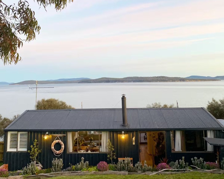 A view of Driftwood Cabin Airbnb overlooking the water in Tasmania