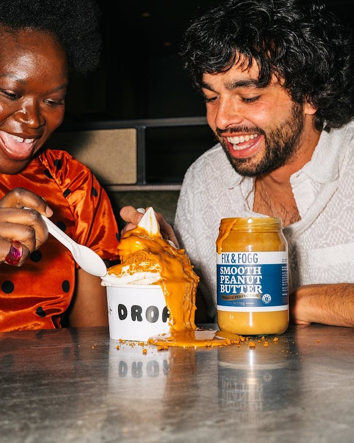 Two happy people tuck into a giant pot of limited-edition Fix & Fogg x Drop'd frozen yoghurt.