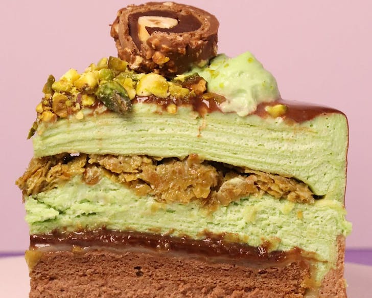 A slice of green Dubai choc, pistachio crepe cake. 