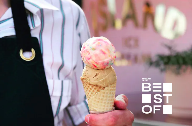Someone holds a colourful ice cream from Duck Island Ice Cream, one of the best ice cream shops in Auckland.