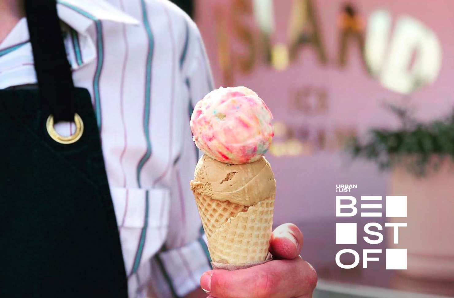Someone holds a colourful ice cream from Duck Island Ice Cream, one of the best ice cream shops in Auckland.