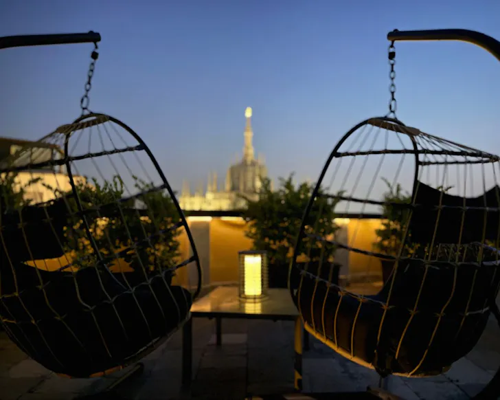 The egg chairs with a view at Duomo Attic Luxury Experience best Milan Airbnbs