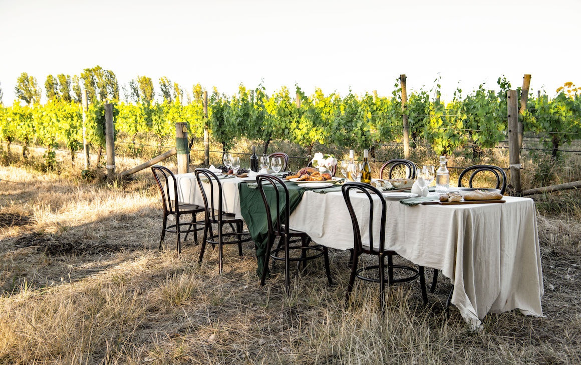 a table set amongst vineyards