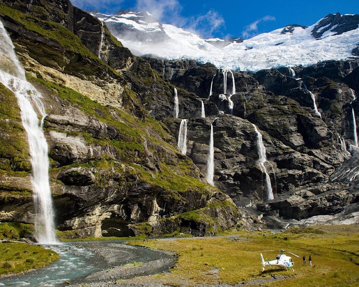 A helicopter lands at Earnslaw Burn mid-tour with Alpine Luxury Tours. 