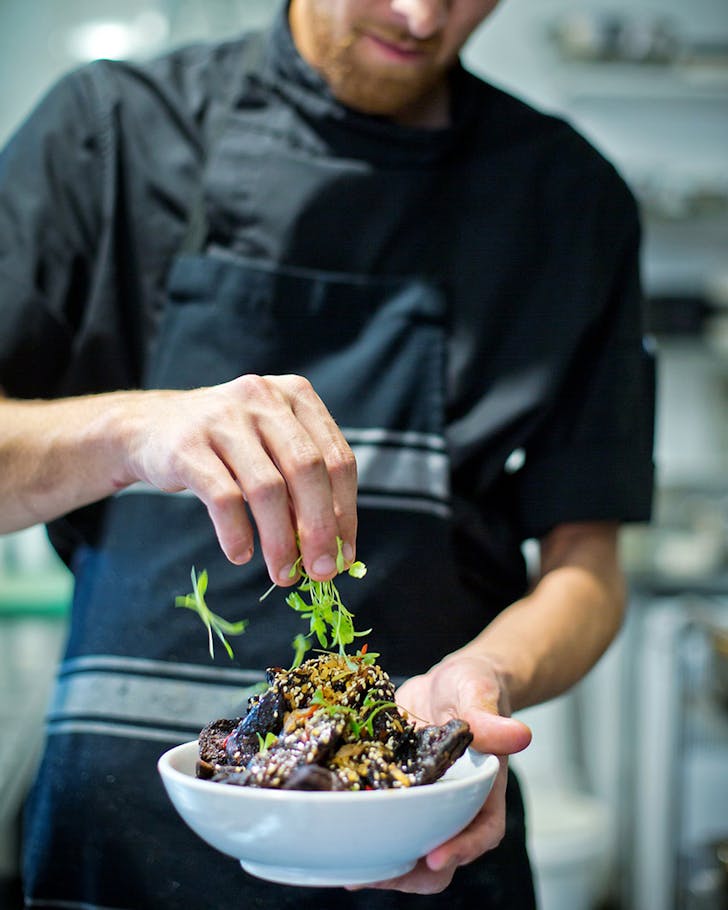 A chef preps a dish at Emerson's Brewery Restaurant in Dunedin.