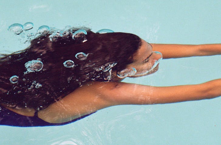 A woman swimming underwater.