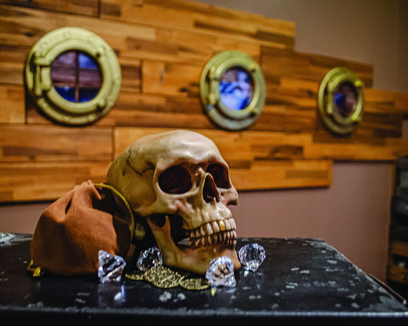 A skull rests on a chest surrounded by jewels in one of the escape rooms at Escape Artists, one of the best escape rooms in Christchurch.