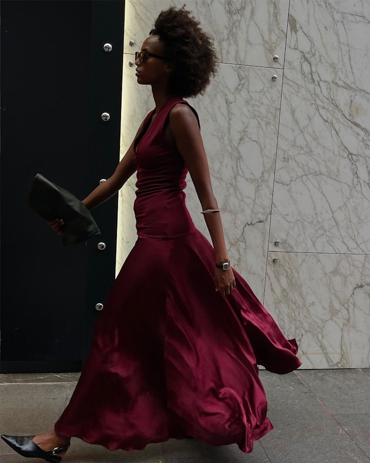 A woman wears a red dress with a full skirt from ESSE Studios one of the best Australian fashion labels