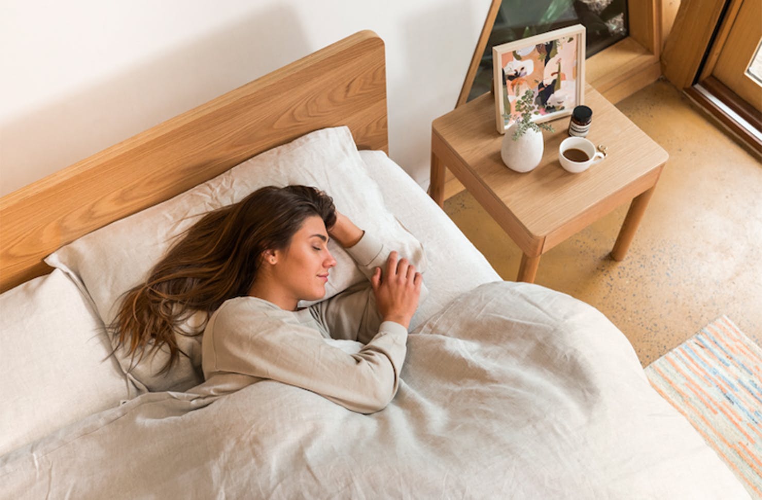 A woman enjoys her new mattress.