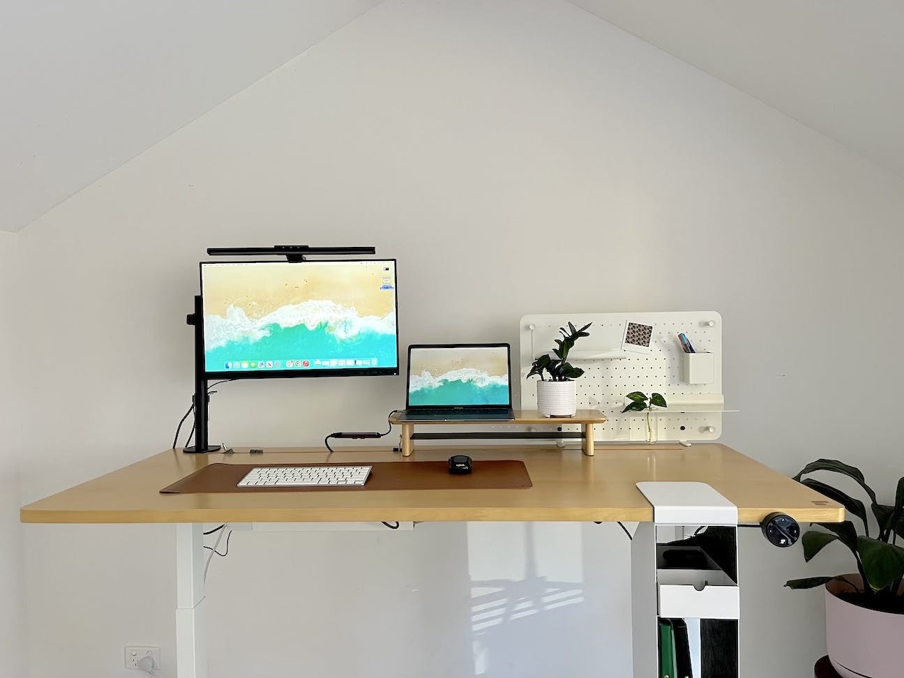 A picture of a laptop and monitor on the stand up desk