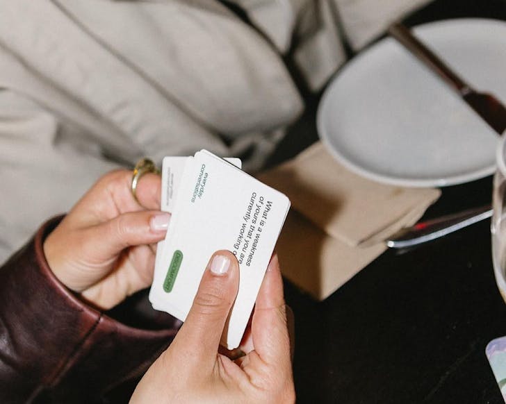 Somebody holds a handful of chic Everyday Conversation cards. 