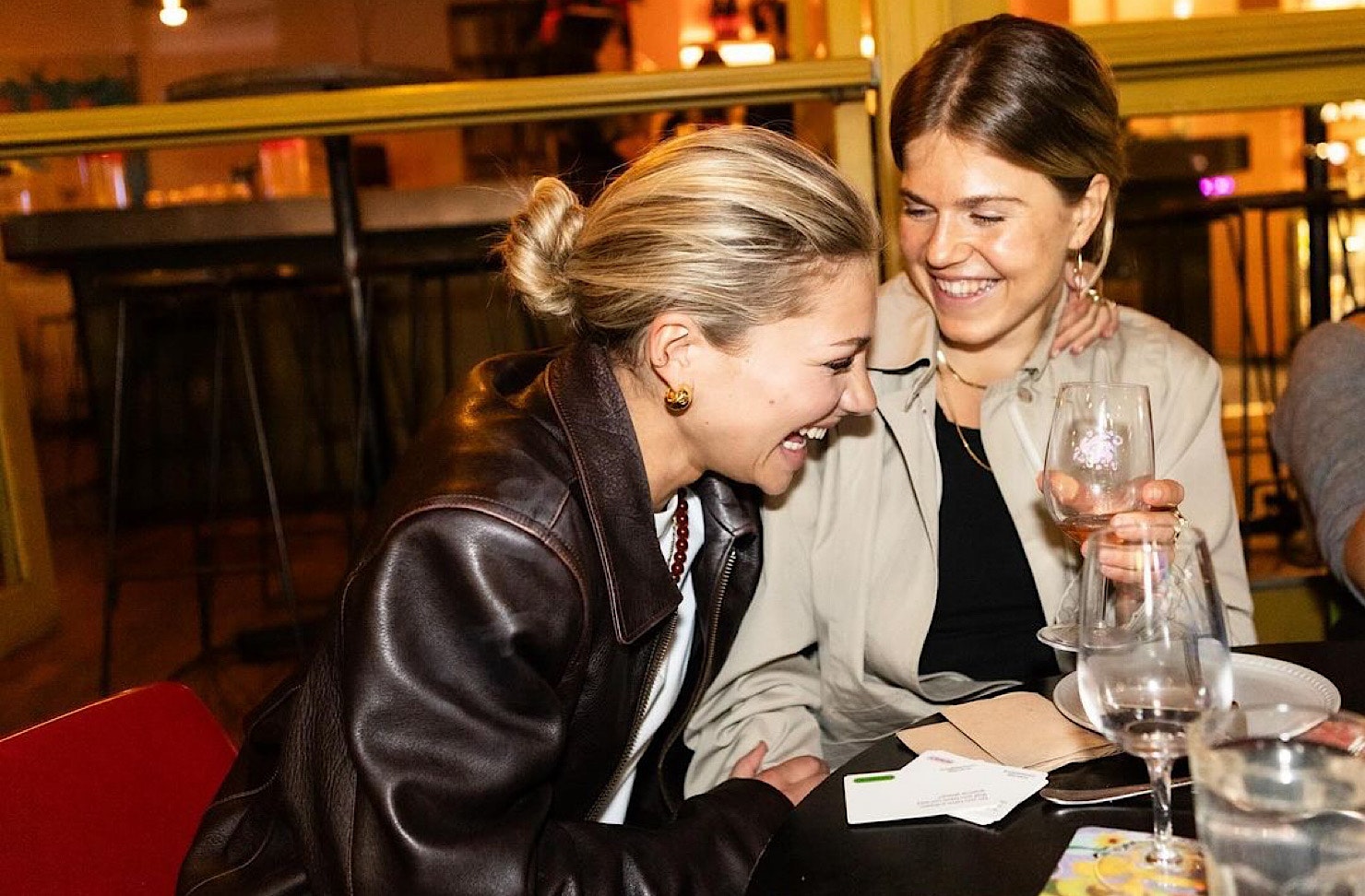 Two women laugh together.