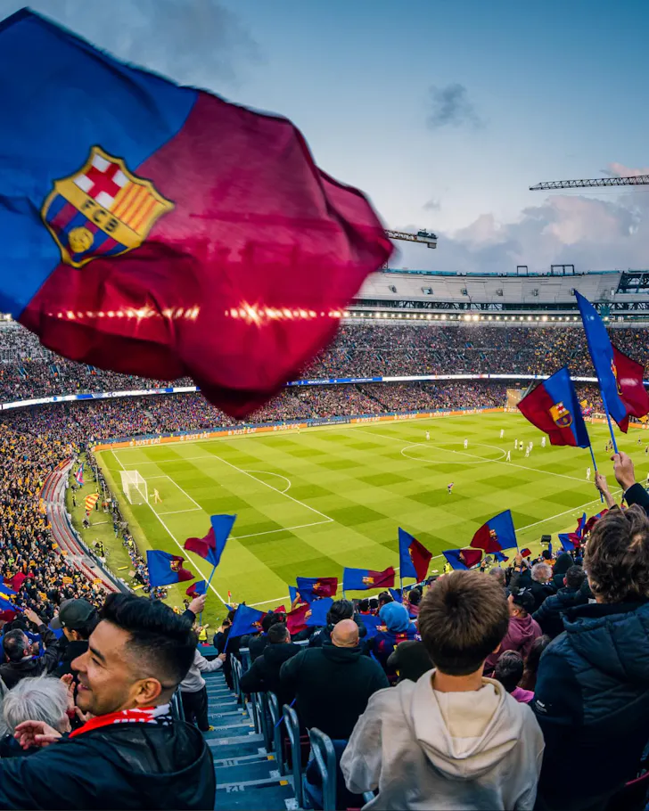 A fan's flag waving in the stadium while watching a FC Barcelona game.