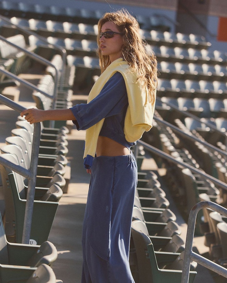 A woman wears sweats from FP Movement By Free People one of the best activewear brands