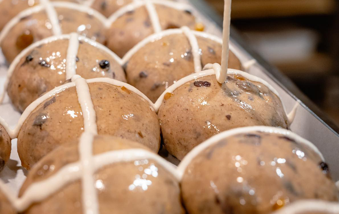 The best hot cross buns in Melbourne being glazed.