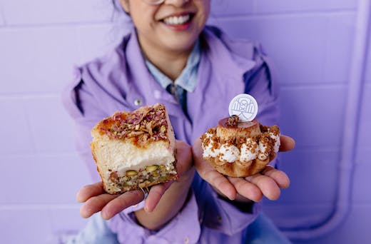 Vicki holds two exquisite cakes.