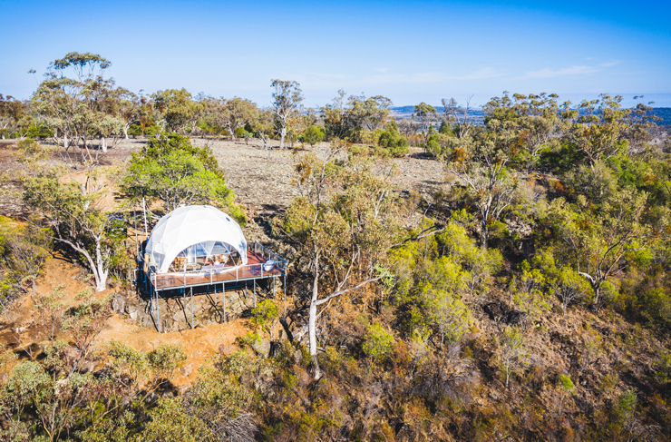 an aerial shot of a white dome tent