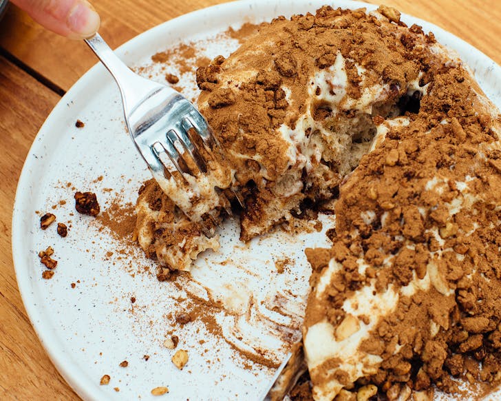 Vicki forks into a giant cinnamon bun