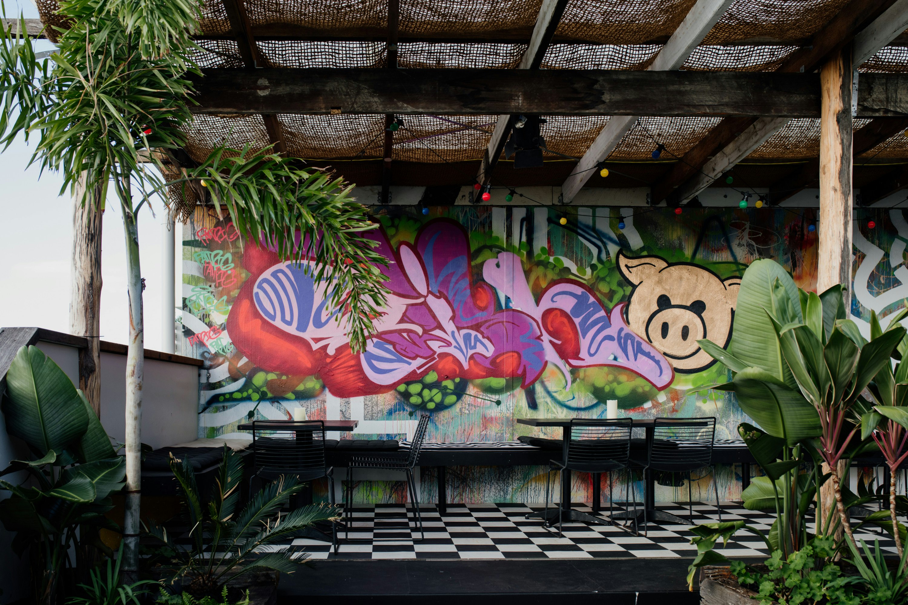 a graffitied rooftop bar