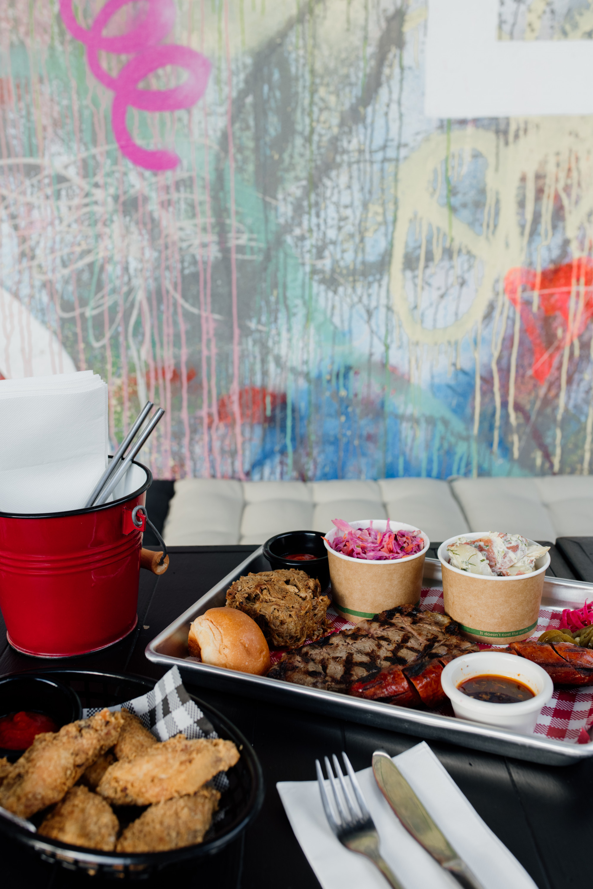 a bbq platter with graffiti in the background