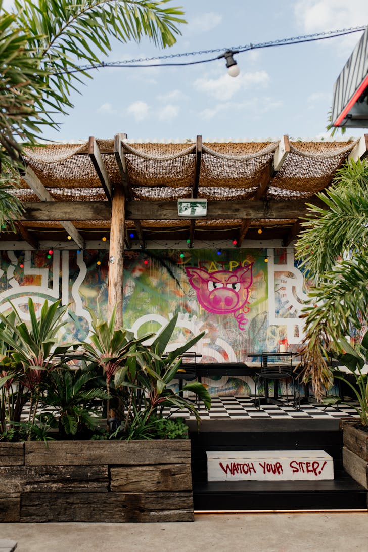 a graffitied rooftop bar
