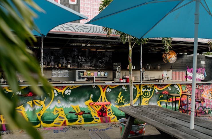 a graffitied bar on a rooftop