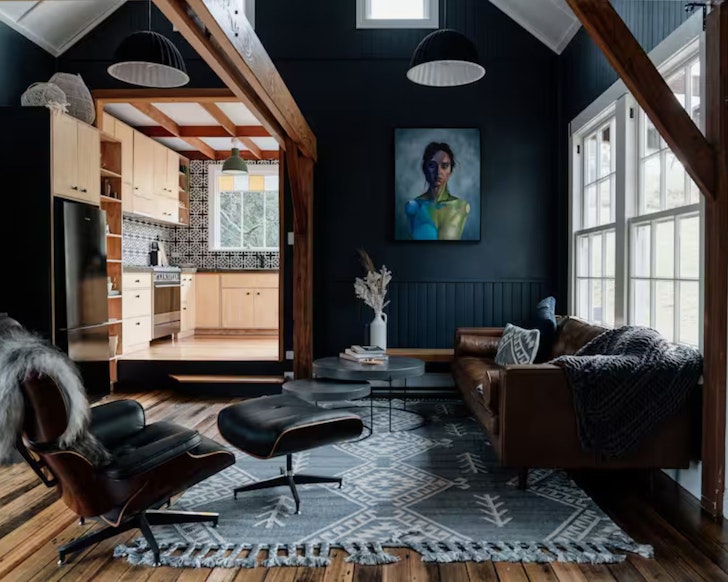 The cosy lounge with a portrait on the wall at Felons Corner Airbnb one of the best romantic getaways in Australia
