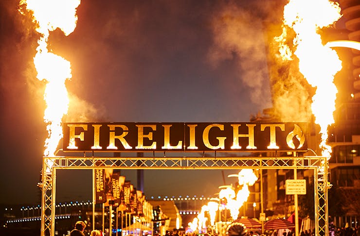 A sign that reads 'Firelight' with large flames erupting on both sides.