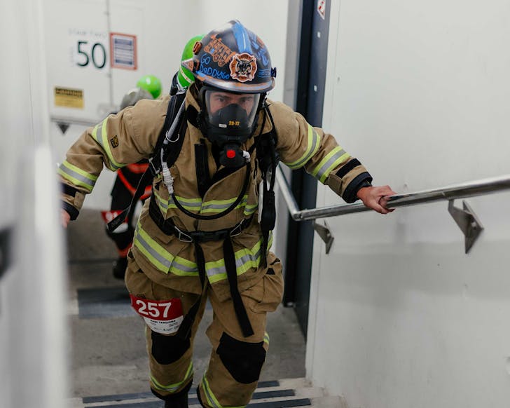 A firefighter climbs up the Sky Tower. 