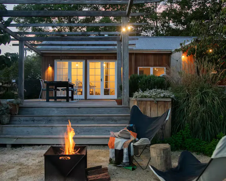 The fire pit roars in front of the house at Firefly Creek Farm Dairy Stay one of the best romantic NSW Airbnbs