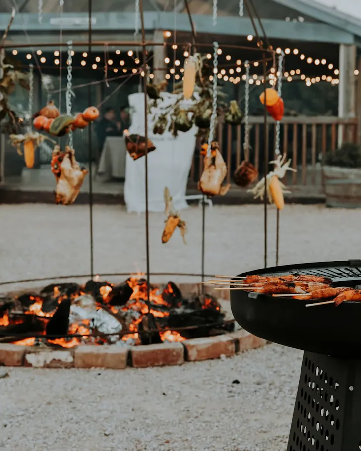 A string of meat and vegetable dangle over the open-flame kitchen at Fireside Feasting at Cleveland Estate