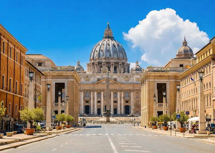 First Timer's Guide to The Vatican with a streetscape showing St Peter's Basicila dome