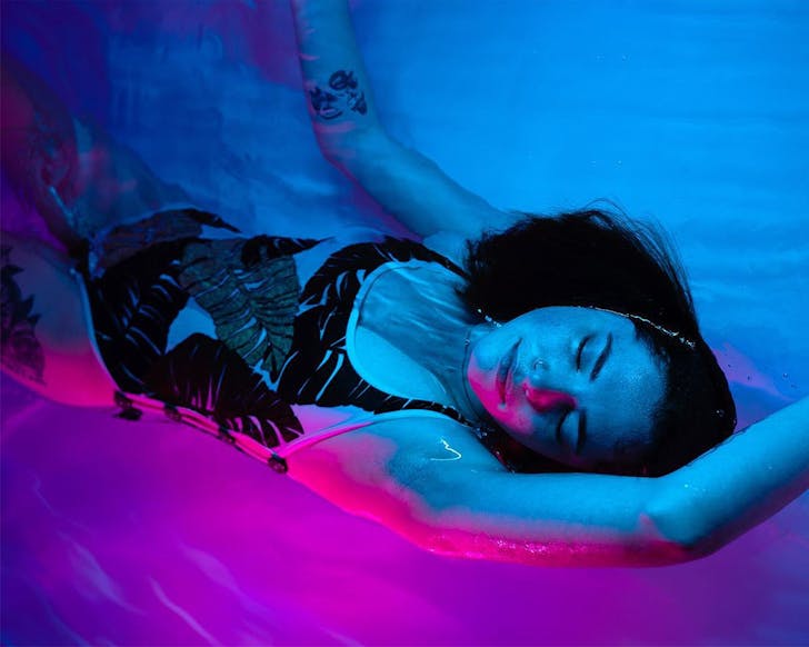 A person floats in a blissful state at Float Culture.