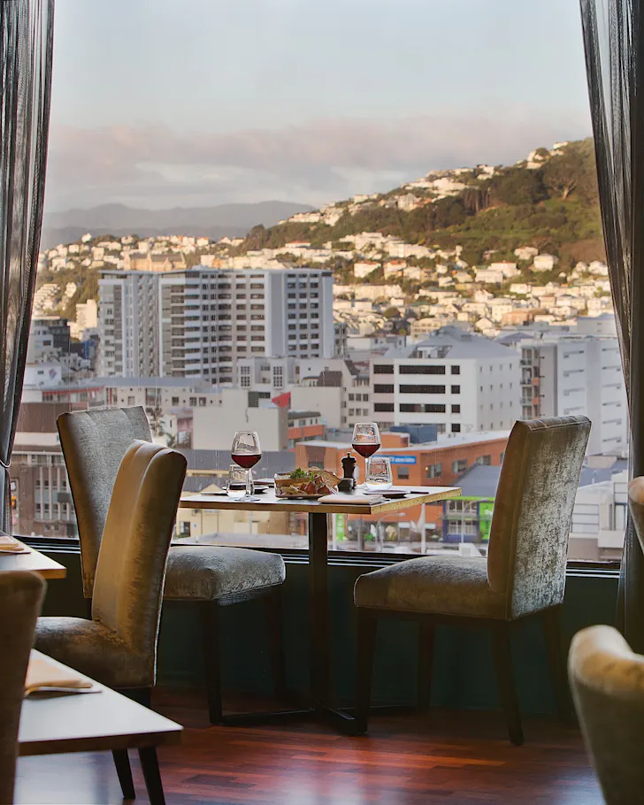 A tidy table setting with a view over Wellington city.