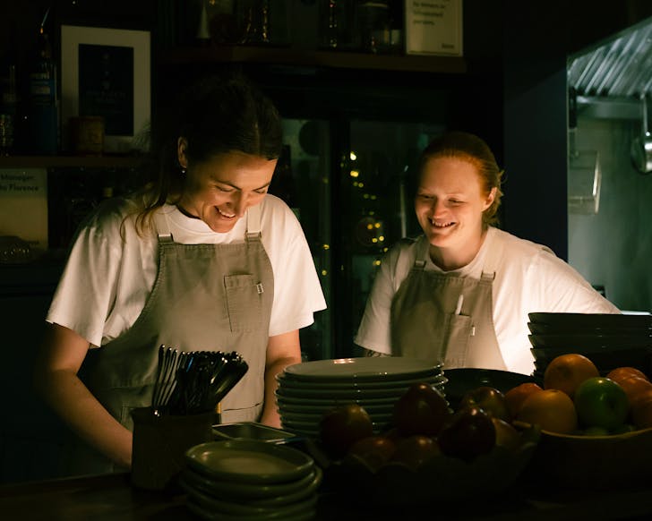 Kate and Plabita stand in the kitchen at Forest. 