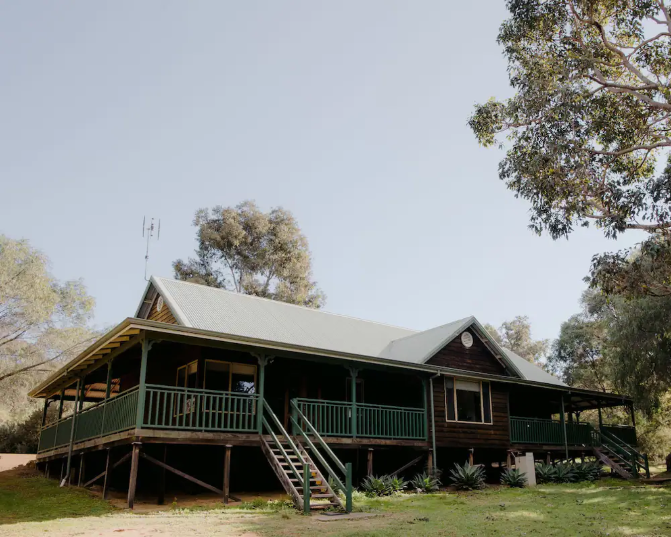 An exterior shot of Yallingup Forest Chalet, surrounded by trees.