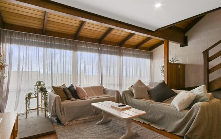 A stylish lounge room with couches, a top accommodation mt hotham option