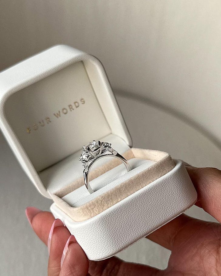 Someone holds a ring box from Four Words, one of the best jewellers in NZ.