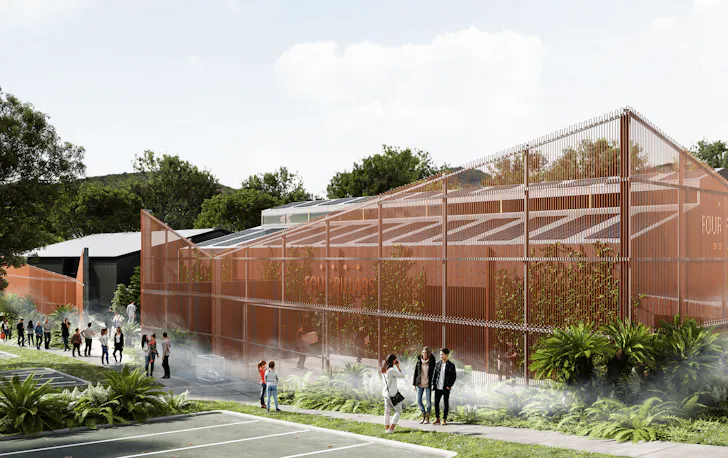 A large copper building with plants and people standing out front. 